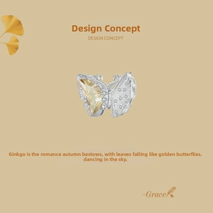 Detailed view of S925 silver butterfly charm with yellow gemstone and brushed texture