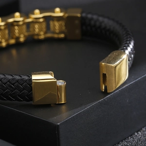Macro detail of male leather bracelet with gold metal chain and magnetic clasp