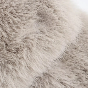 Close-up of soft faux fur fabric texture in taupe showing high-density plush fibers