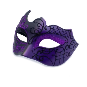 Close-up of purple and black glitter masquerade mask with intricate hand-painted patterns