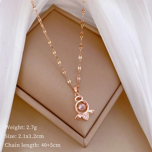 Detail view of rose gold heart pendant with wings and gemstones in an elegant gift box