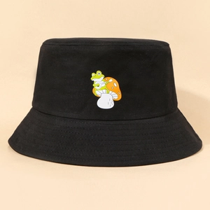 Detail of embroidered green frog and mushroom on a black cotton wide-brim bucket hat