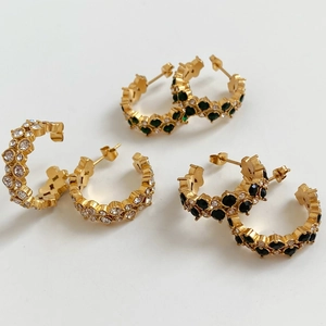 Three pairs of gold C-shaped earrings with two rows of inlaid zircons on white background