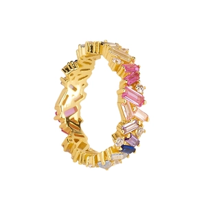 Irregular gold wave ring featuring multi-colored baguette-cut cubic zirconia gemstones