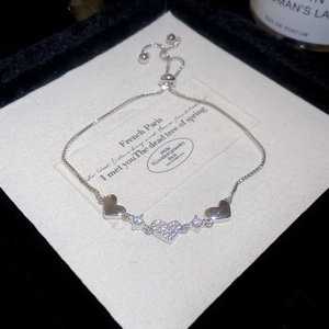 Close-up of heart-shaped bracelet with pave zircon details and sliding clasp design