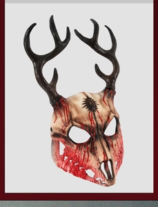 Detailed view of skull mask with black antlers and red blood splatter for Halloween