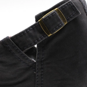 Close-up of adjustable vintage bronze metal buckle on black cotton beret cap