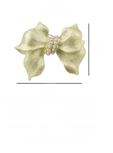 Detailed view of gold alloy bow brooch with pearl and dimensions 4.2cm by 3.6cm