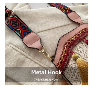 Close-up of golden metal hooks and colorful woven strap on a summer bucket bag