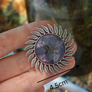 Detail of 4.5cm sunflower brooch with purple dried flower resin and silver base