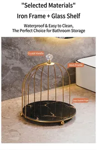 Detail of golden birdcage organizer with marble texture glass tray and crystal top handle