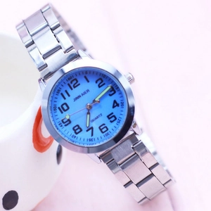 Detailed macro view of the silver metal strap and the blue watch face with luminous hands