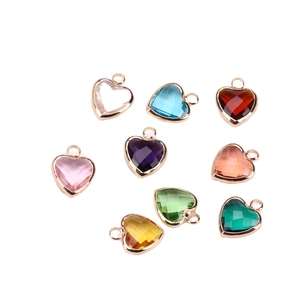 Set of nine multi-colored heart-shaped crystal pendants with gold metal frames