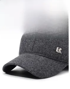 Detail view of the thick gray wool baseball cap featuring a metallic R logo and curved brim