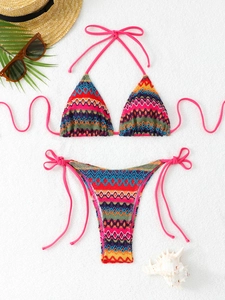 Detailed view of bohemian knit bikini with colorful geometric patterns and pink ties