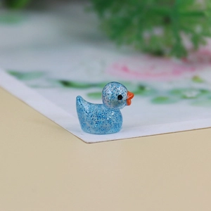 Close-up of a blue glitter resin mini duck figurine for DIY miniature landscapes