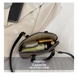 Internal view of a retro brown crossbody bag showing space for lipstick and cosmetics