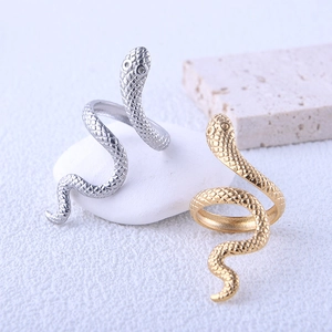 Detailed view of snake-shaped rings in gold and silver with intricate scale textures