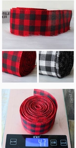 Macro shot of plaid Christmas linen ribbons in black, white, and red checkered patterns