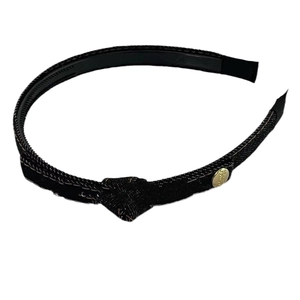 Black knotted denim headband with gold logo pendant and inner teeth for secure grip