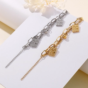 Double-layer stainless steel chain bracelet with gold and silver engraved pendants