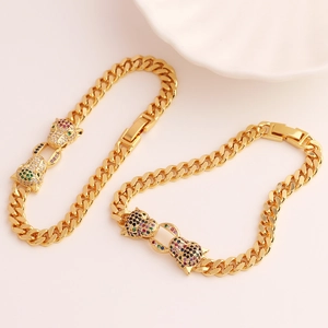 Detail of gold Cuban chain bracelet featuring leopard heads with multicolor zircon stones