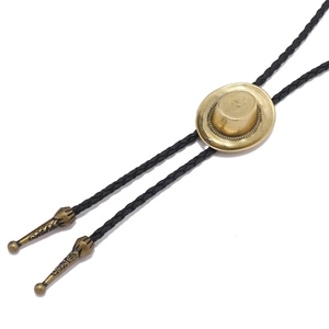 Western style golden cowboy hat bolo tie with black braided cord on white background
