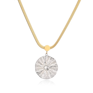 Detailed view of bicolor pendant necklace featuring a gold snake chain and silver textured disc