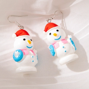 Detail view of cute snowman earrings with red Santa hat and pink scarf for Christmas