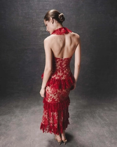 Back view of a red lace halter dress featuring open back design and layered ruffles