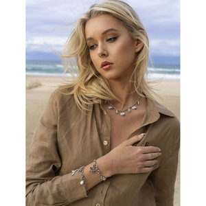 18K gold stainless steel necklace and bracelet set with ocean shells on beach
