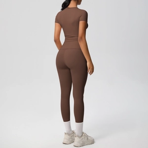 Detail of high-waist yoga pants and t-shirt in dark brown moisture-wicking fabric