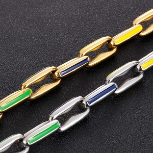 Macro shot of Cuban chain links featuring gold, silver finishes and colorful enamel inlay
