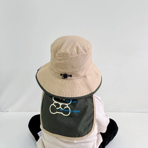 Detail of baby sun hat with khaki neck flap and green bear print featuring adjustment buckle