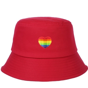 Detailed view of red cotton bucket hat with colorful rainbow heart embroidery patch