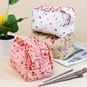 Quilted cotton makeup bags with floral patterns, ruffles, and zipper closure for travel