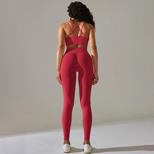 Red two-piece ribbed yoga set featuring cross back sports bra and high waist leggings
