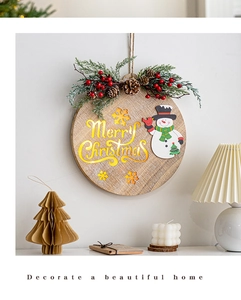 Detail of wooden Merry Christmas hanging sign with snowman and pine cone decor