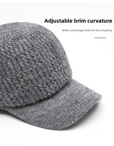 Detail of grey knitted baseball cap showing foldable brim and textured wool fabric