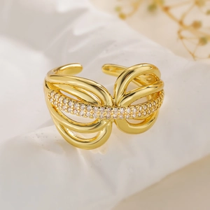 Gold plated geometric open ring with zircon pavé stones on a stone display