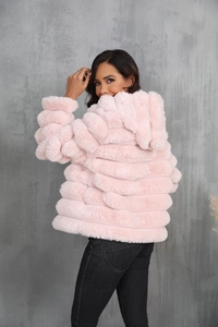 Detail view of pink faux fur hooded jacket showing segmented stitching and soft texture