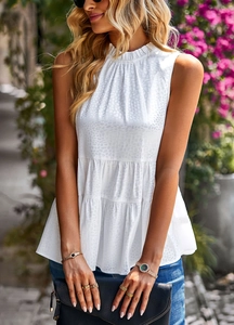 Detail of white sleeveless high-neck top with ruffled tiered design and animal texture