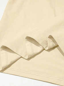 Detailed view of cream cotton fabric texture with premium double-needle stitching seam