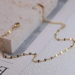 Elegant minimalist gold and black ripple link chain bracelet with secure lobster clasp