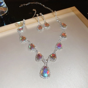 Detailed view of silver square jewelry set with rainbow stones and tiny diamonds