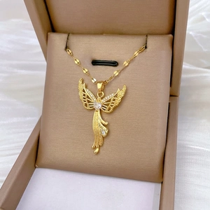 Golden angel wing pendant necklace with zircons on white silk background display