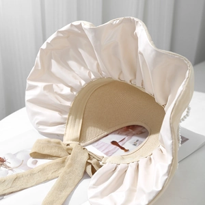 Elegant beige sun visor for women with satin brim, ribbon bow and pearl details