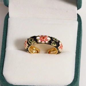 Detail of floral enamel ring with colorful hand-painted flowers in a jewelry gift box
