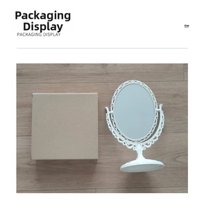 Detailed view of vintage white oval vanity mirror with floral frame and packaging box