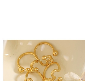 Close-up of vintage gold-plated titanium earrings with elegant twisted texture details